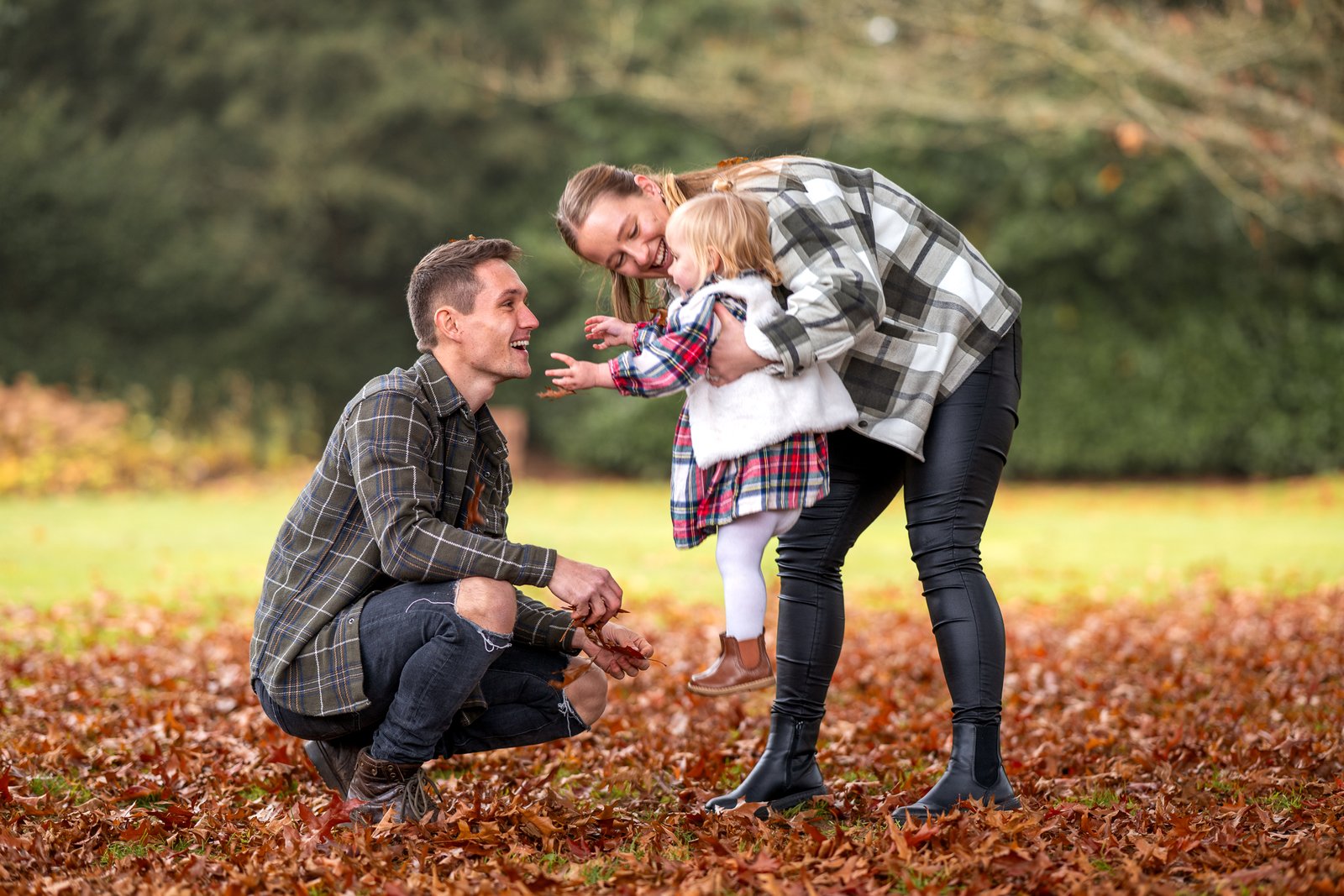 Mum and dad playing with their daughter