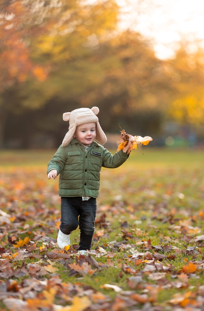 Boy playing with leaves Boy playing with leaves