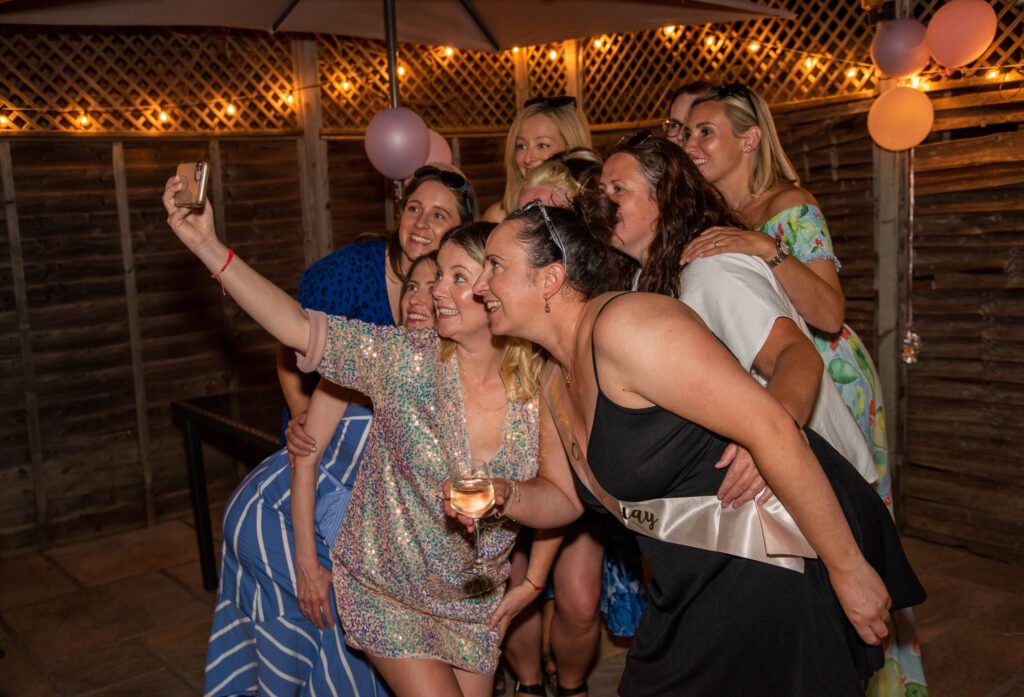 Friends taking a selfie together at a birthday party Friends taking a selfie together at a birthday party