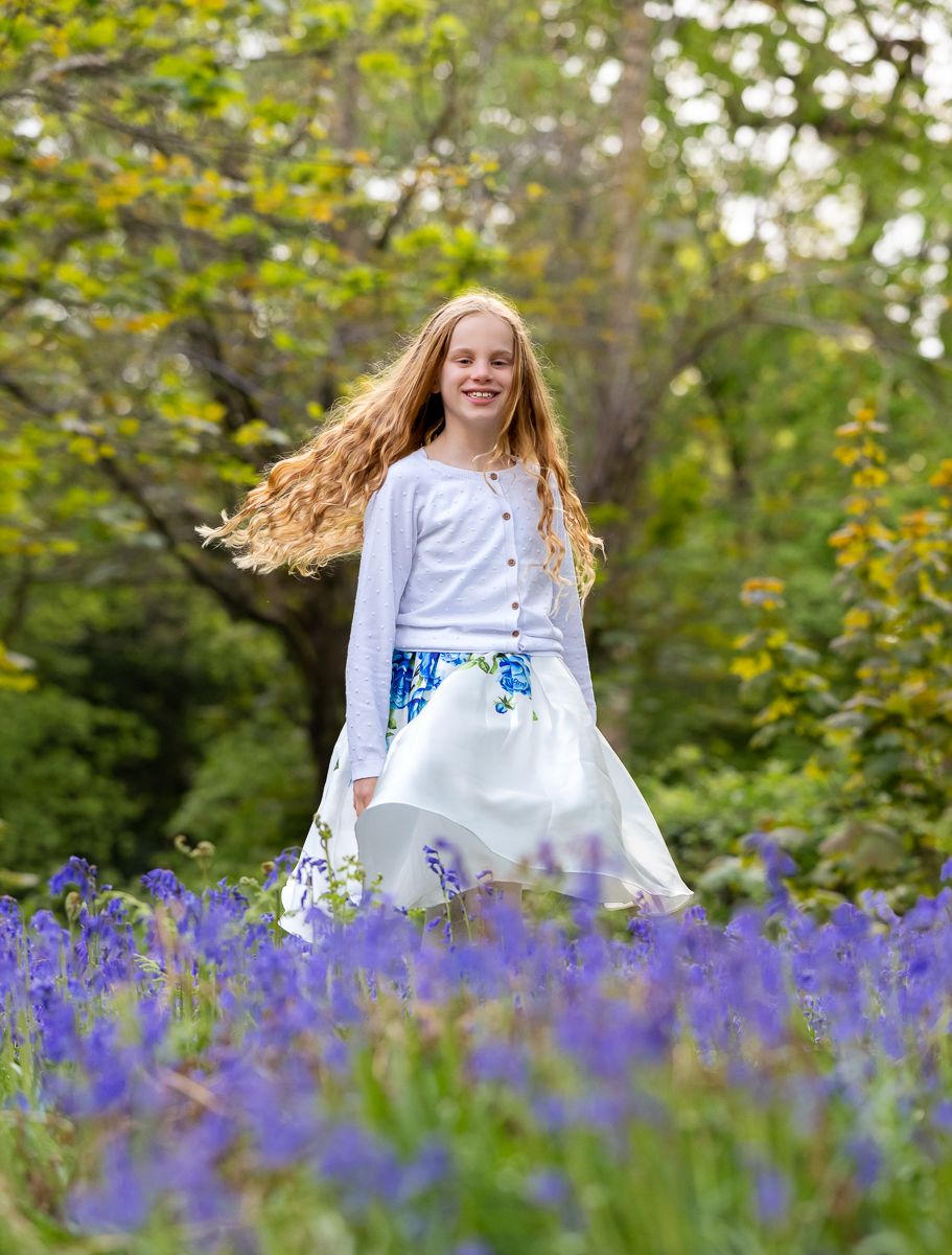 Girl standing amongst bluebells