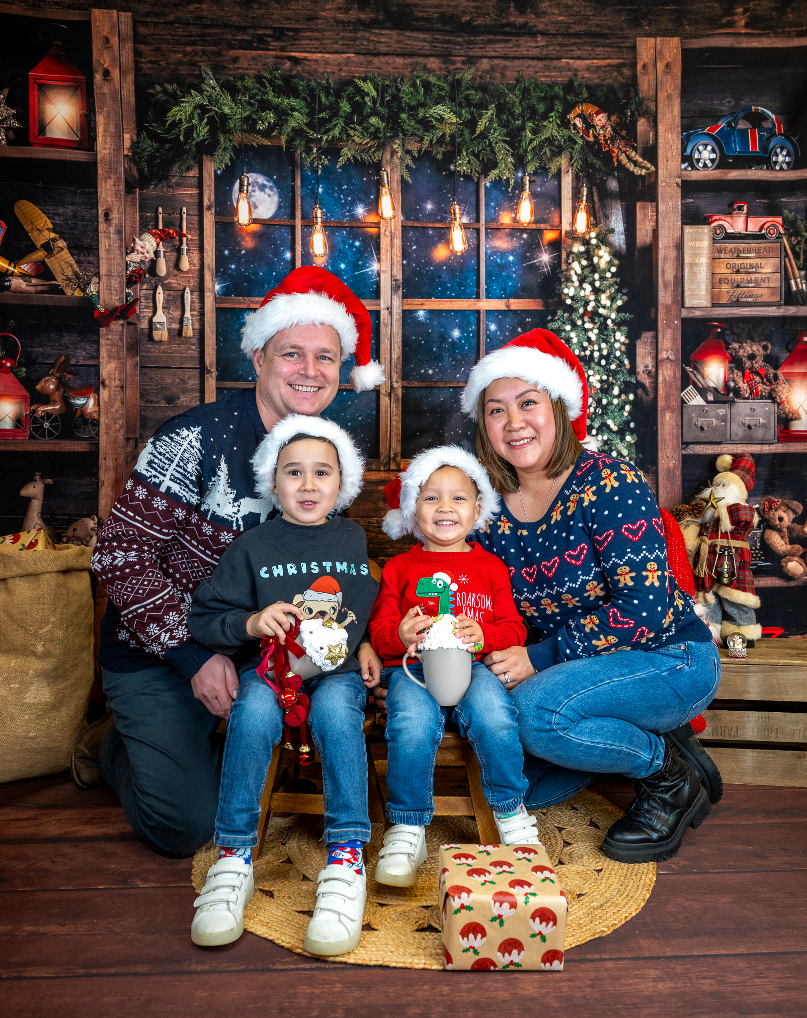 Family of 4 on a Christmas backdrop