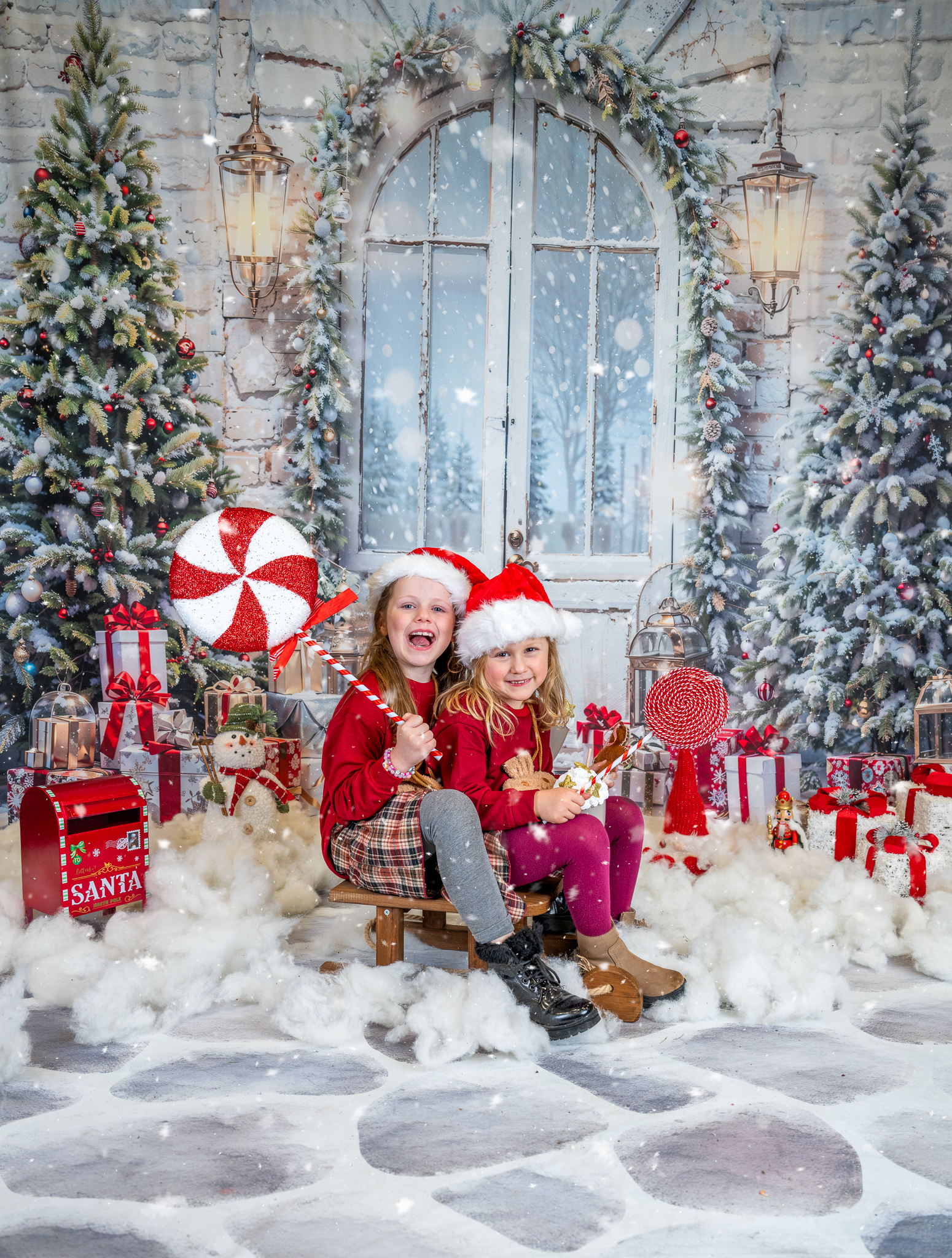 Two girls holding Christmas props