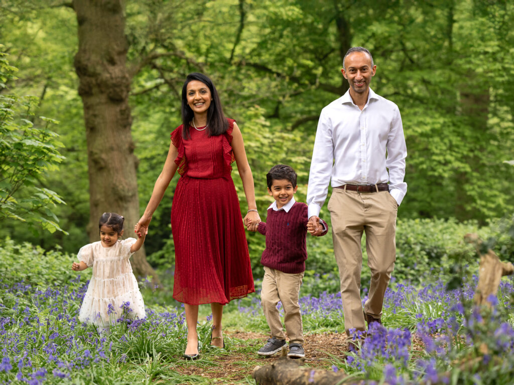 Family walking amongst the bluebells