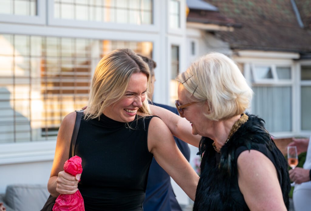 Two women at a party laughing