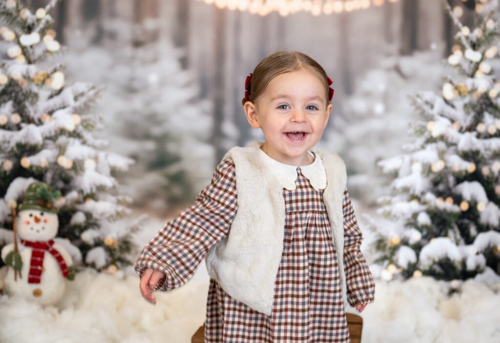 Girl laughing and playing in the snow